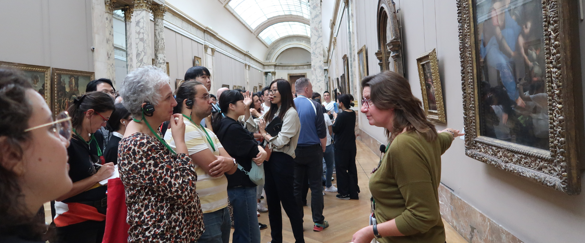 Une conférencière au Louvre devant du public